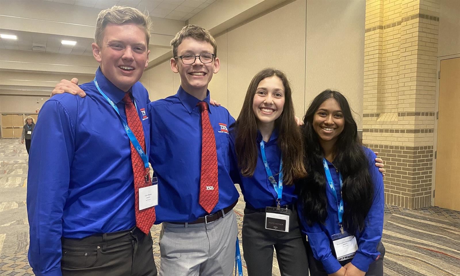 four students smile
